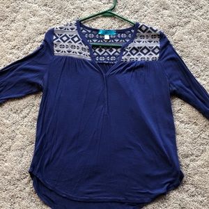 3/4 length sleeve blouse with geometric pattern.